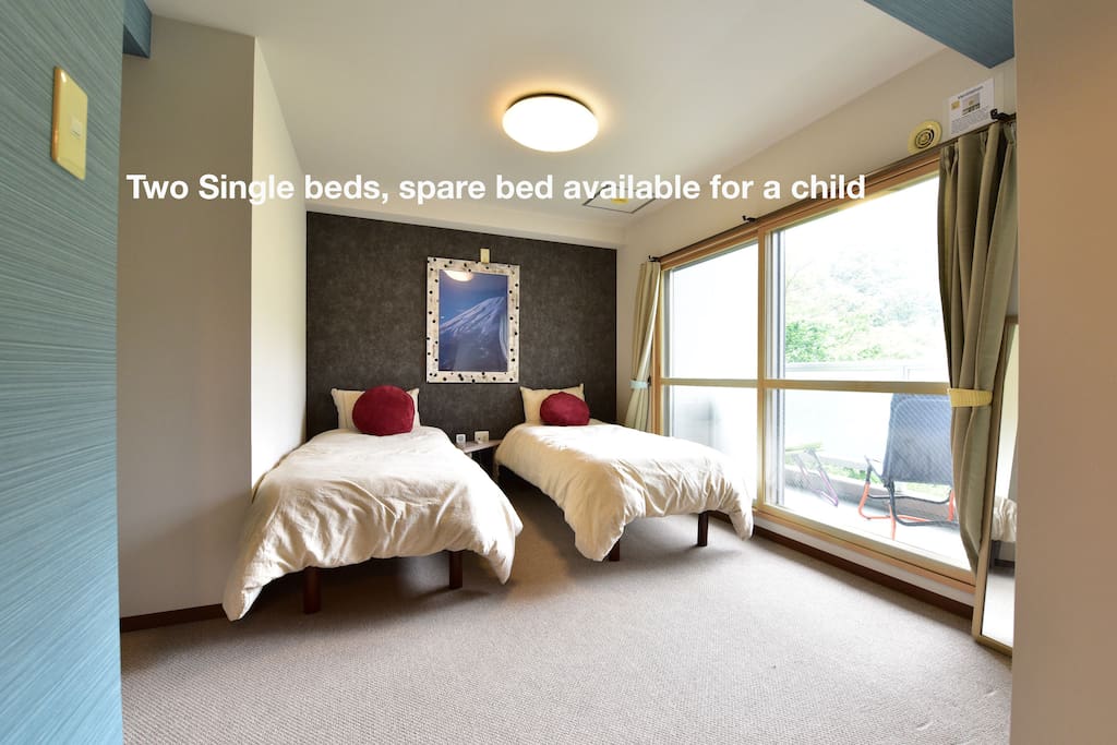 Two single beds with a spare cot for children