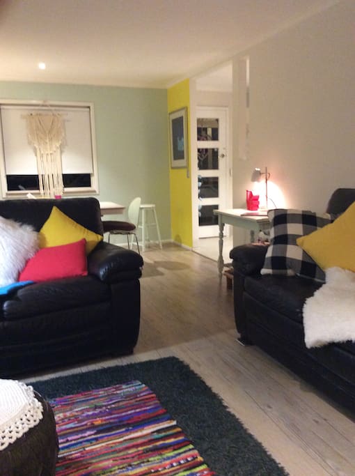 Lounge leads to dining area , kitchen and front entrance .