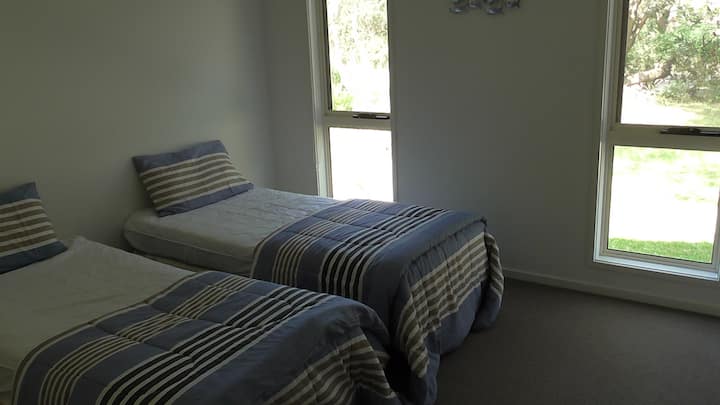 Second bedroom has two single beds.