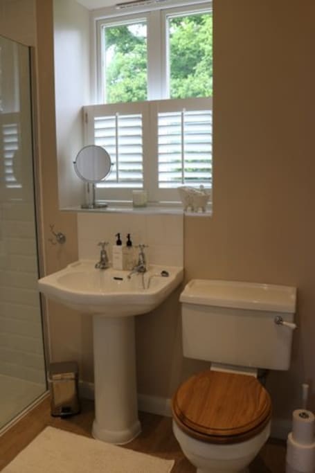 En suite bathroom with shower, basin and toilet. Underfloor heating and heated towel rail.