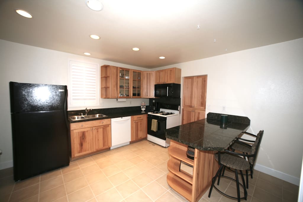 Beautiful hickory and granite kitchen stocked with lots of utensils, pots & pans, slow cooker, coffee machine, etc.