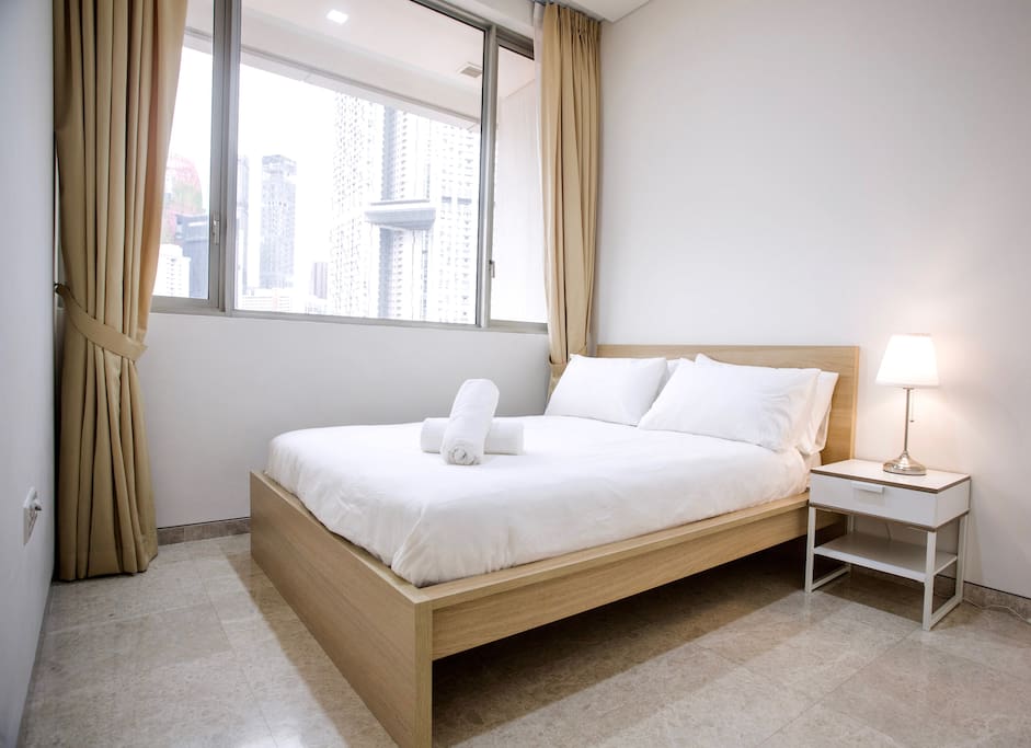 Second bedroom with queen bed and private bathroom.