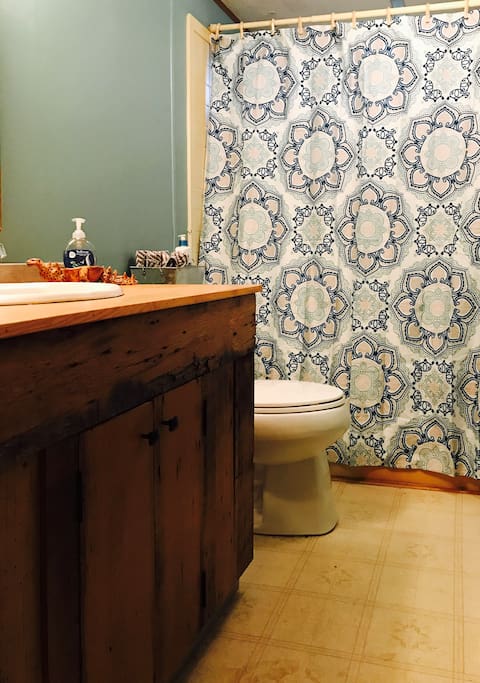 Bathroom with custom cabinet built from barn boards found on the land.