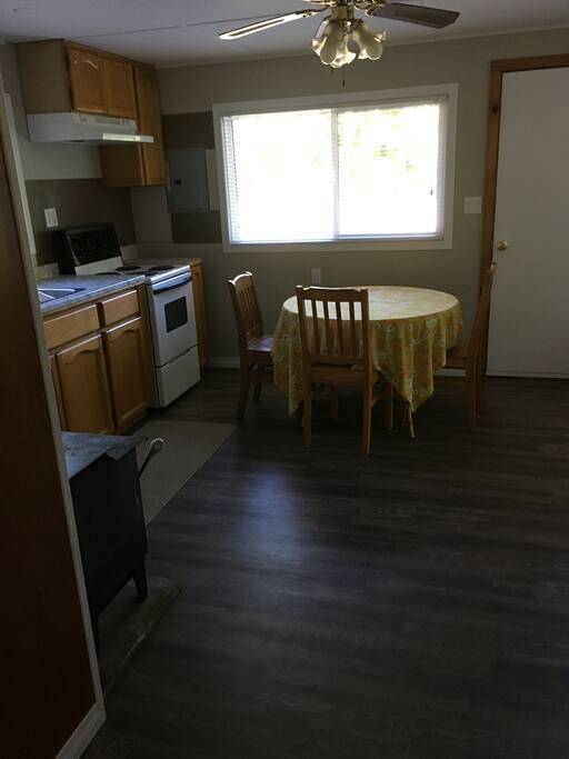 The kitchen area: fully stocked with cutlery, plates, cups, mugs, pots, pans, toaster, coffee maker, mixing bowls, oven mitts...the works.