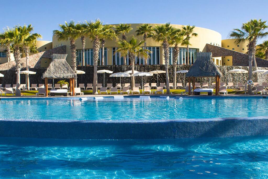 Lounge chairs and beds surround the outdoor pool.