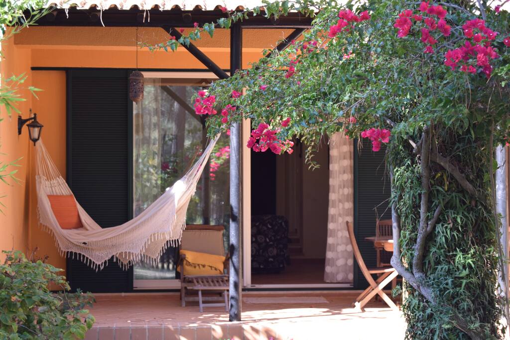 Back Garden (view to Aroeira II Golf Camp) with a dinner table, Barbecue, hammock and Sun lounger