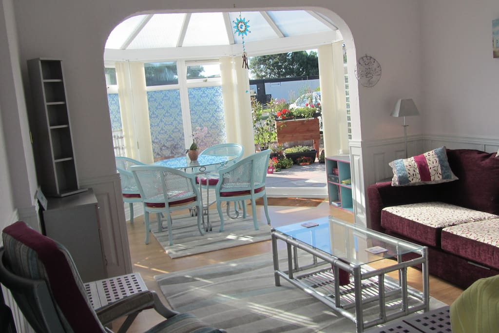 Lovely open plan living area with sun lounge leading to patio