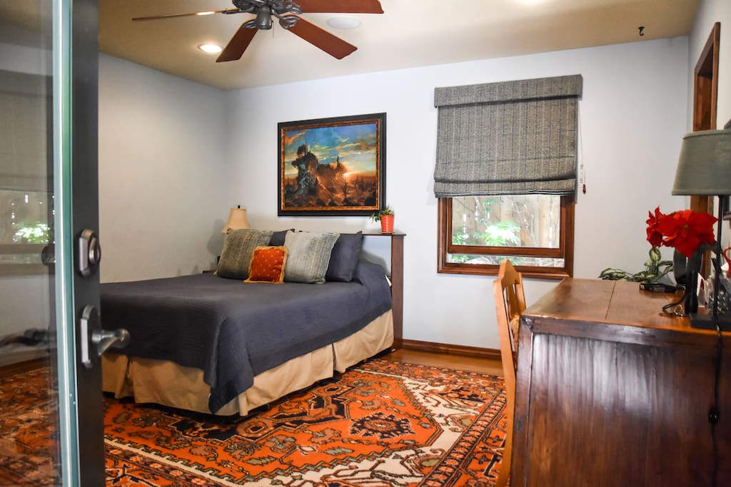 The inviting bedroom has its own entrance from the back yard so come and go as you please. Includes queen size bed, private bath with shower, flat screen TV, desk, and walk-in closet.