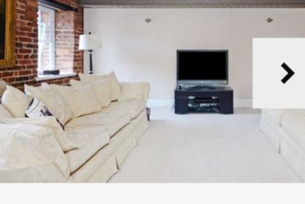 Living room with large 4 seat and 3 seat sofas and flat screen TV,blue ray player, cable tv box with Netflix ,and Sony sound system ,