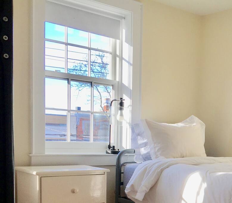 Freshly painted, front sunny bedroom with twin and bunk bed and a lovely view of Main Street. Brand new white linens