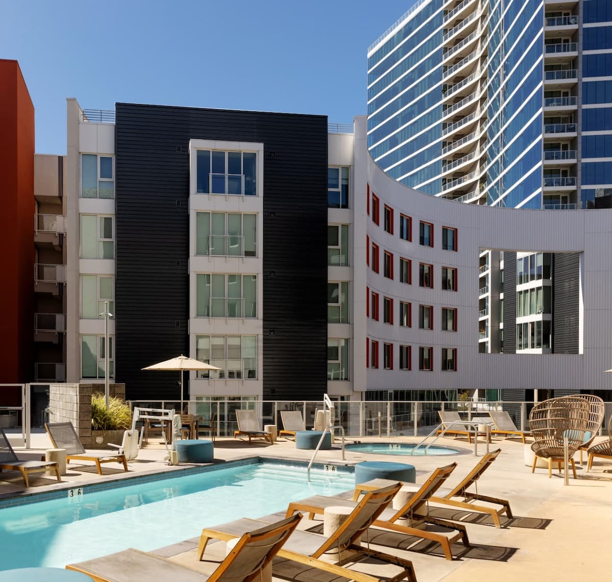 Image of a pool in an apartment complex courtyard on a sunny day
