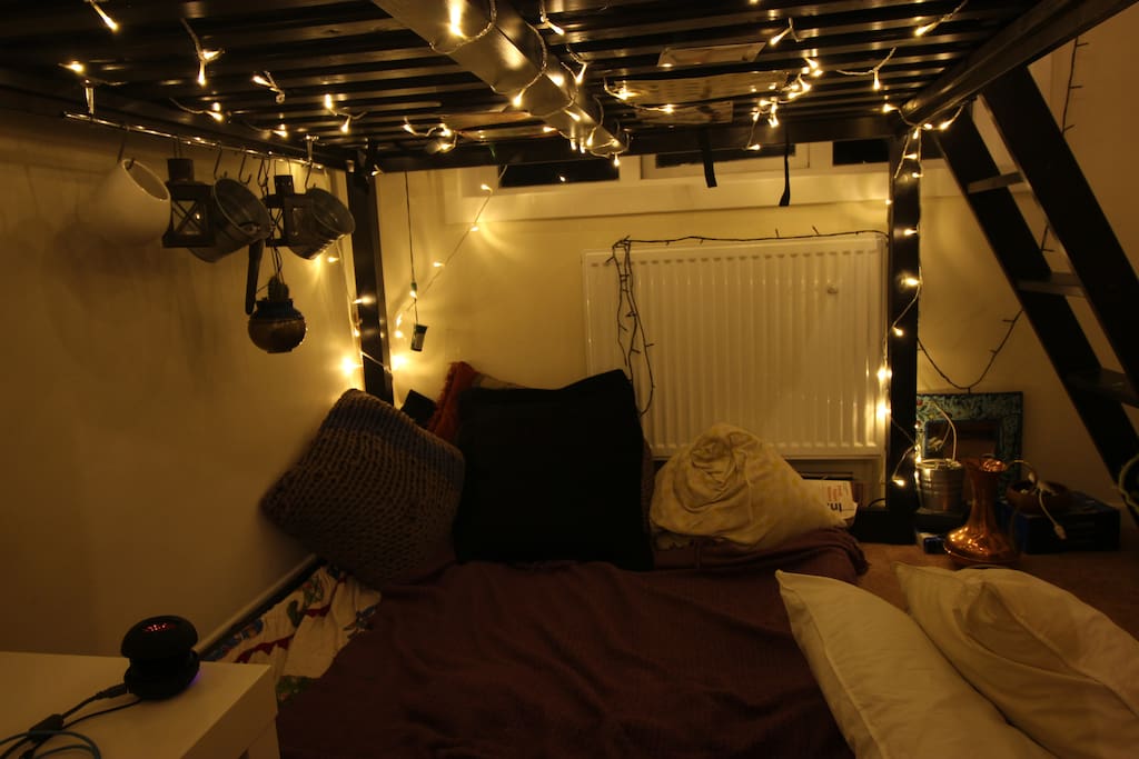 Under the bed, pillows, lights and blankets make for a very hygge world.