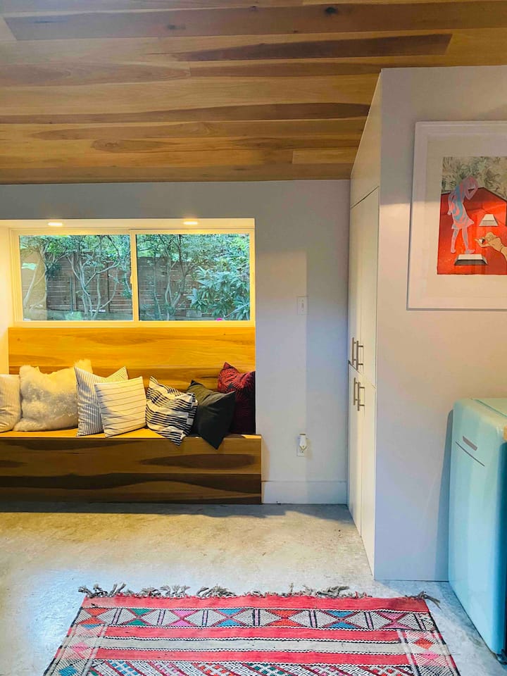 Find some extra seating among plush pillows on the built-in wood bench. 
