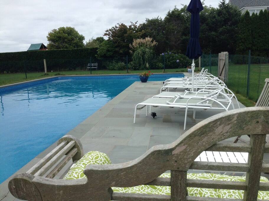 Comfortable seating/lounging in separate blue stone patio and deck areas.