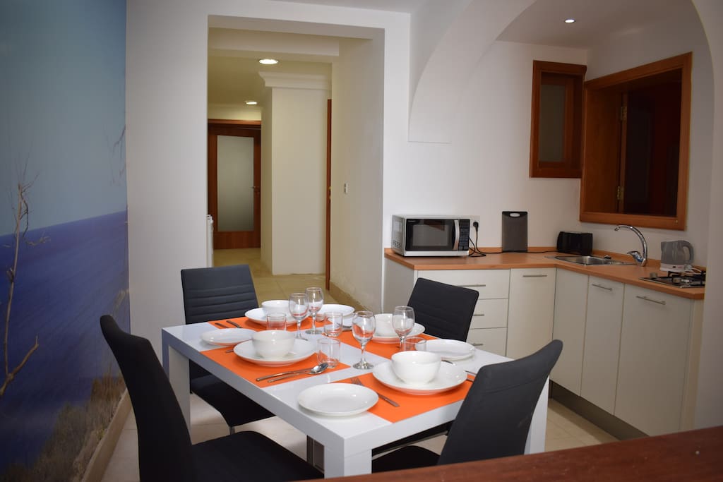 First to meet the eye is the fully equipped kitchen and dining area