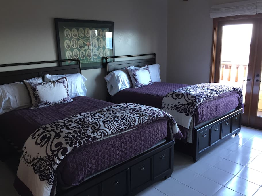 Two bedrooms with two FULL size beds leading to balcony