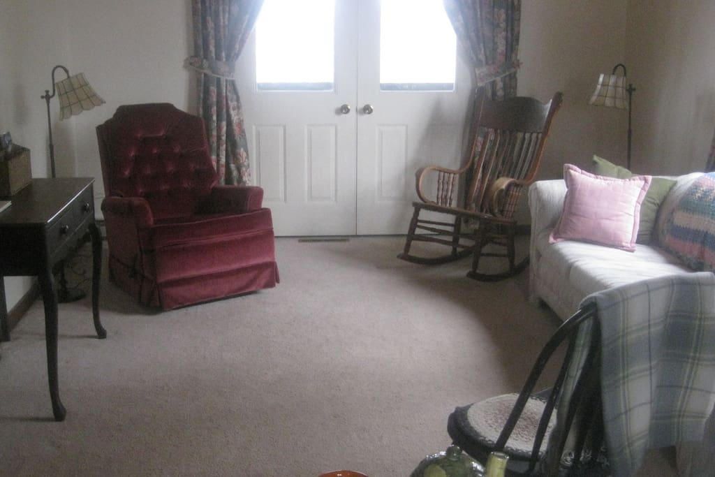 Living room, door to deck, queen sized sofa bed.