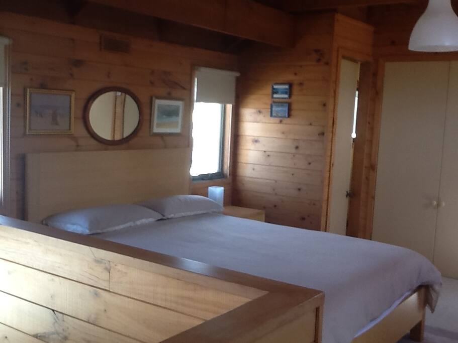 Upstairs mezzanine bedroom .Queen bed plus toilet/sink.
Entry to upstairs balcony.