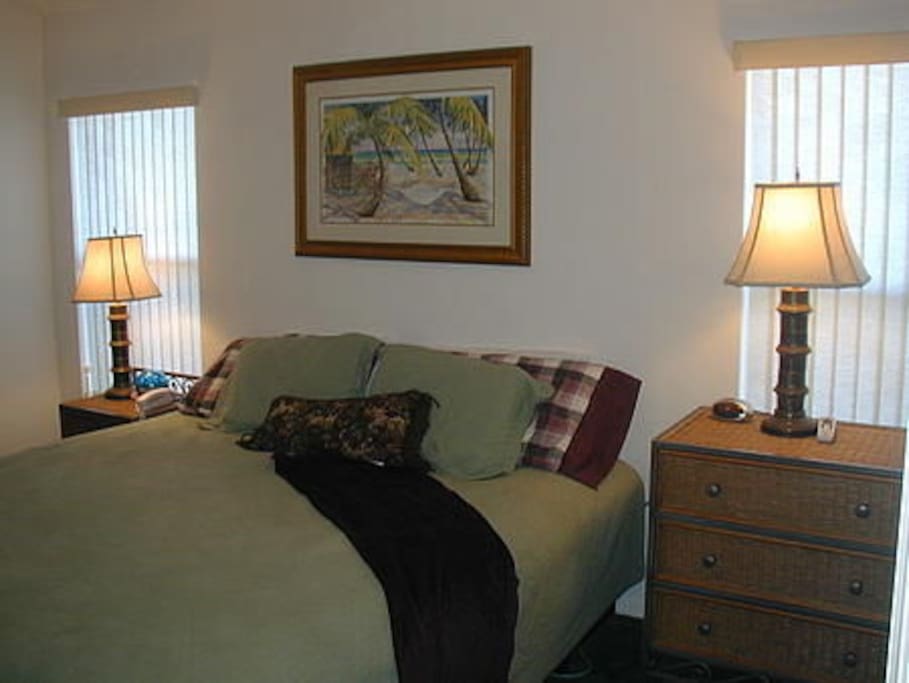 Master bedroom with ensuite bathroom and king-size bed.