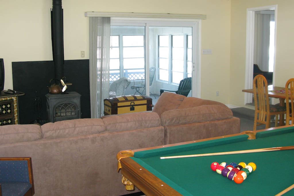 Games room, with pool table, fireplace, large flat screen tv, pin ball machine.