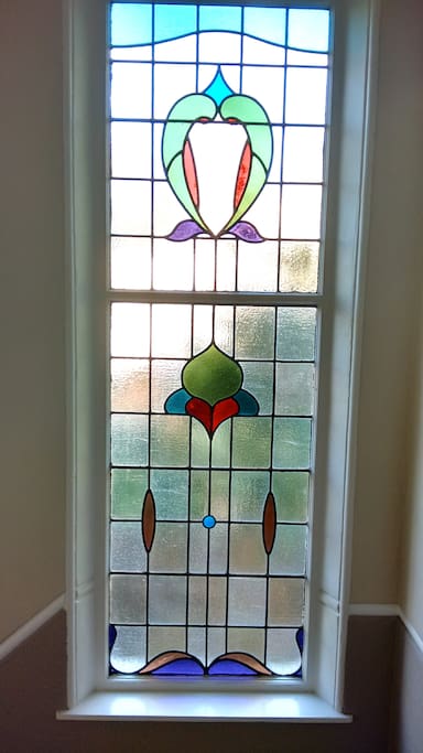The flat has lots of beautiful period features such as stained glass windows