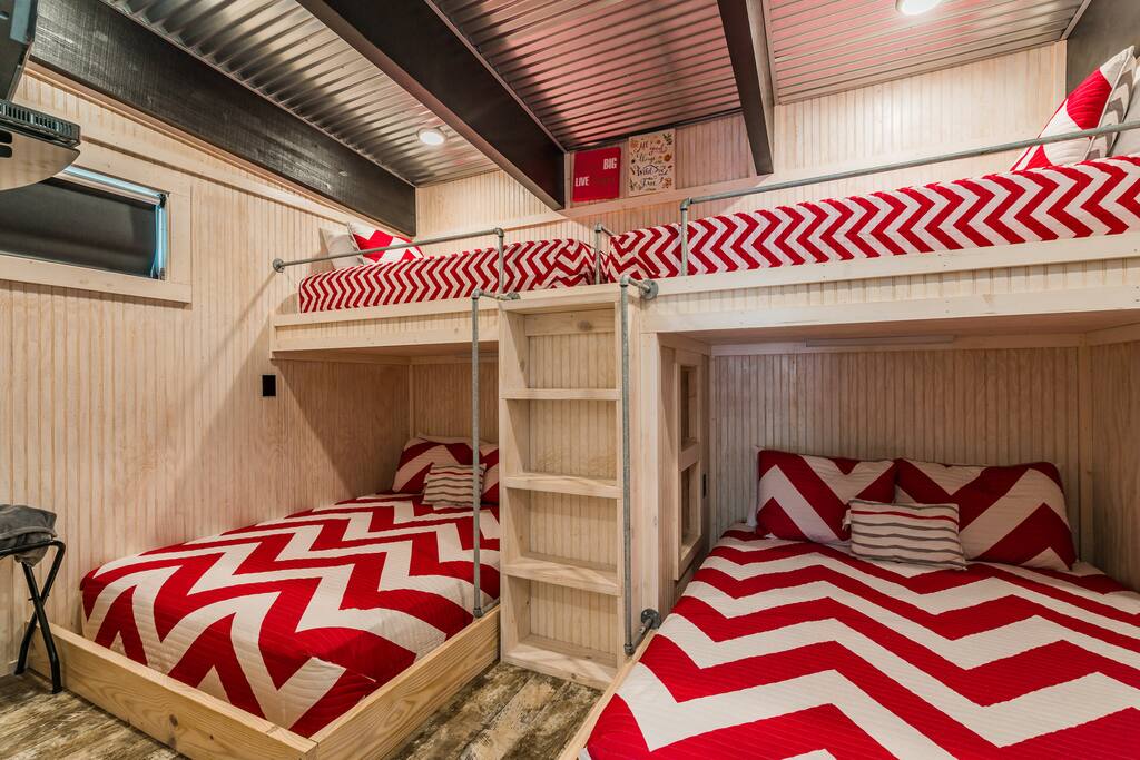 Bedroom with 2 queens, 2 twins, AC/heat unit, oscillating ceiling fan, and flatscreen cable TV