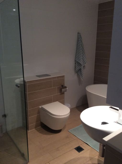 Full bathroom with free standing bath, shower and double sinks