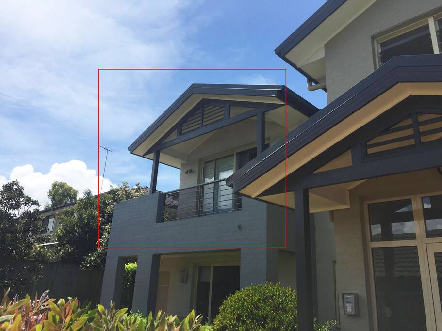 Back of apartment with balcony off the master bedroom