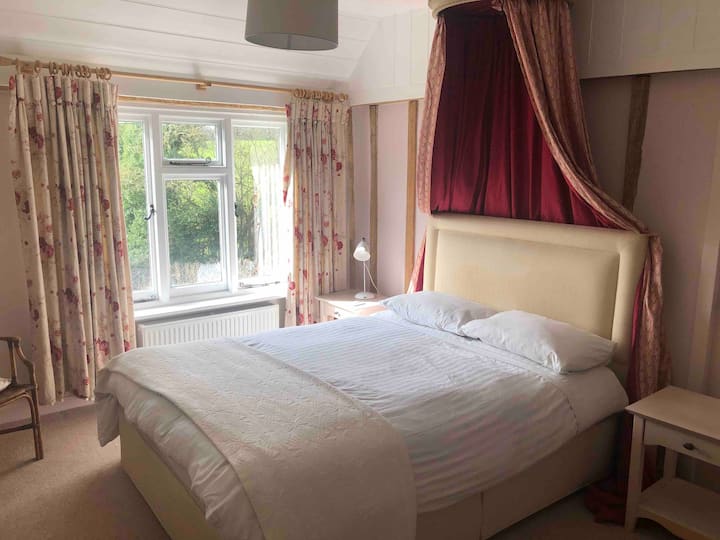 Large double bedroom with views over the garden and fields beyond. 