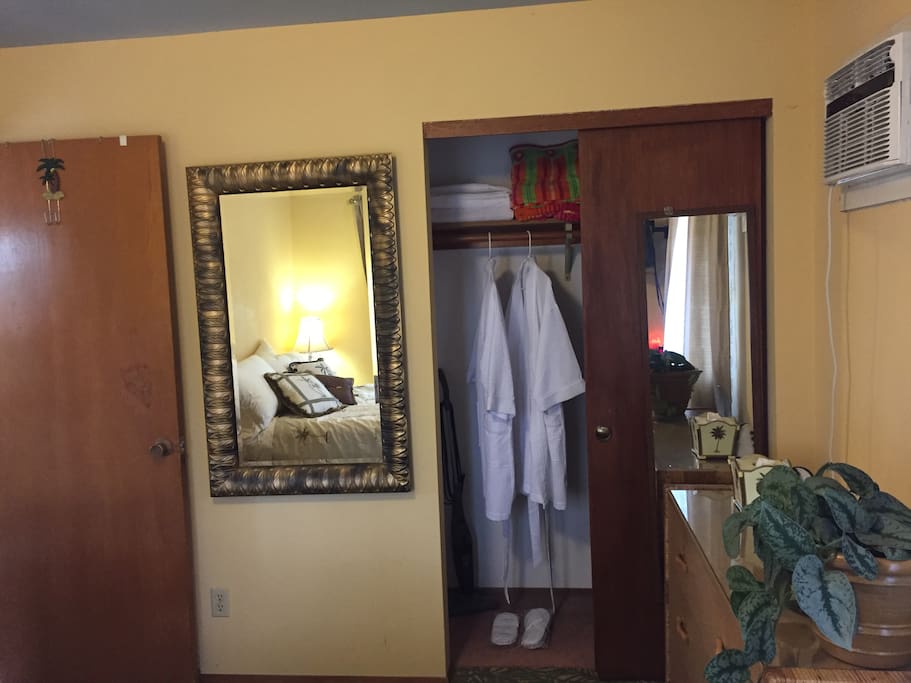 Closet with slippers robes and towels