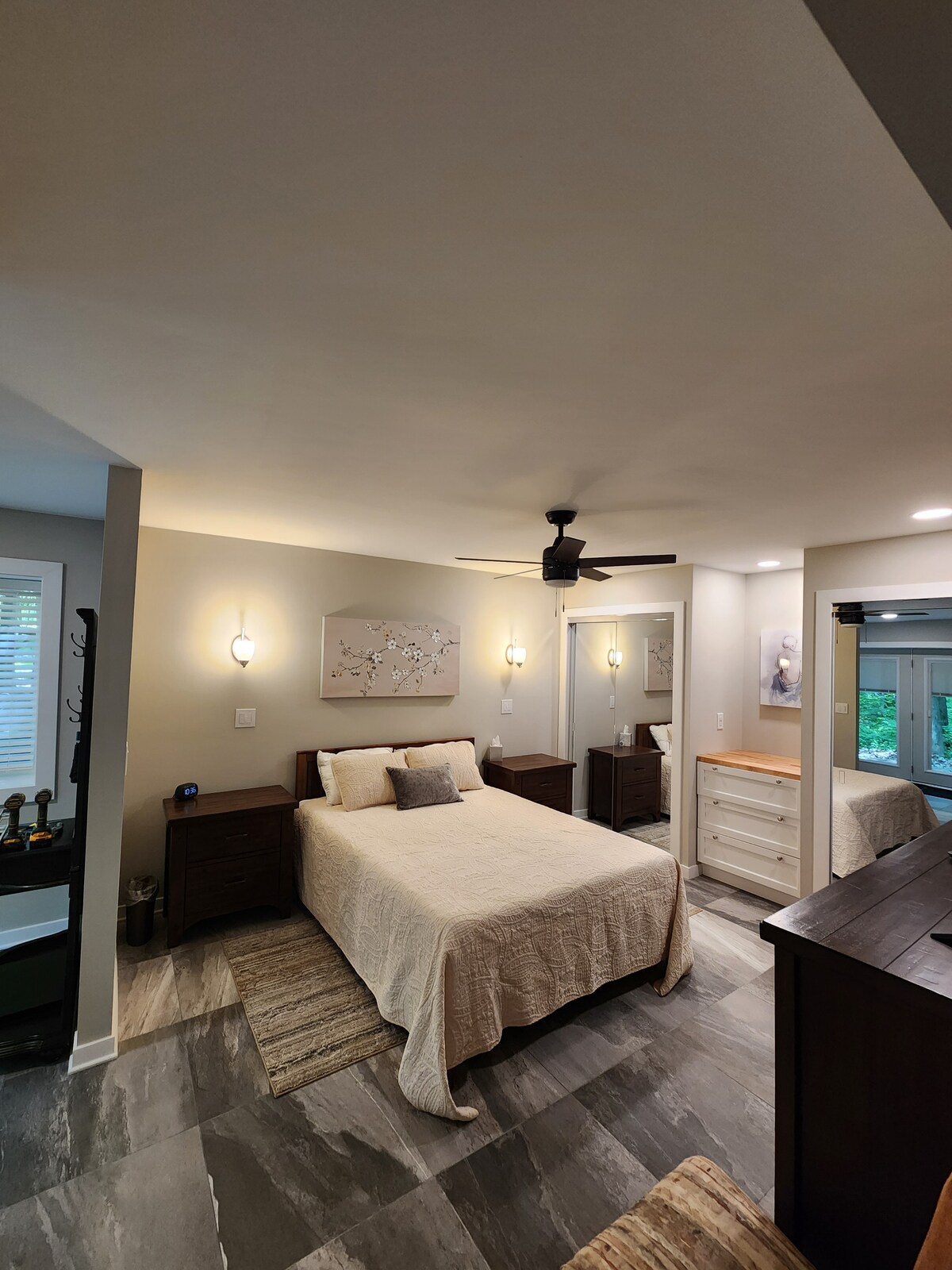 Lower level - bedroom with queen bed, two closets, storage cabinet and dresser.