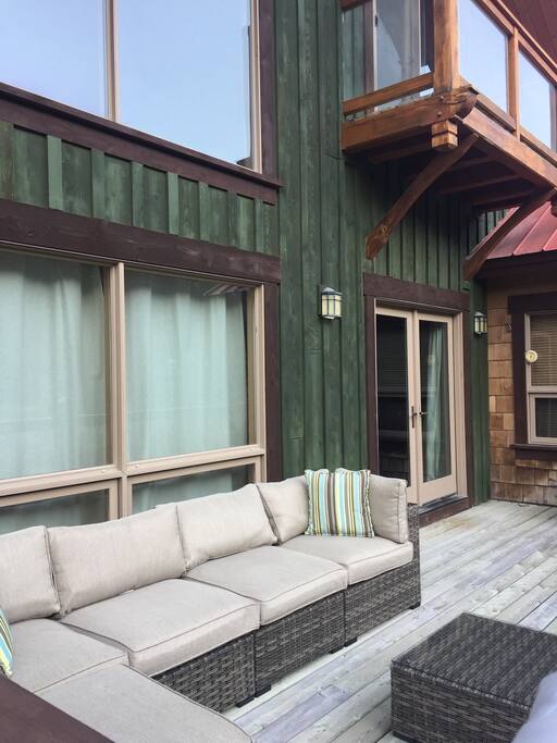 Lounge furniture on deck off main Living area provides a cozy spot for enjoying summer evenings outdoors.
