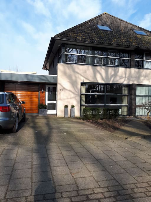 Facing the house with parking place for 2 cars