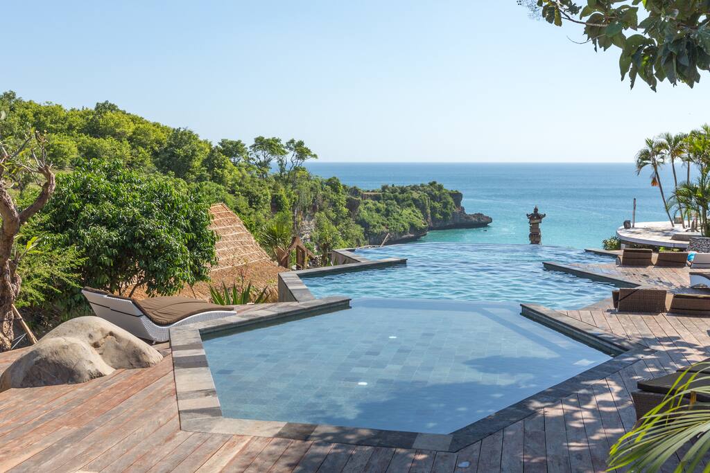 Three-tier honeycomb infinity pool during sunset. Hear the ocean waves below.