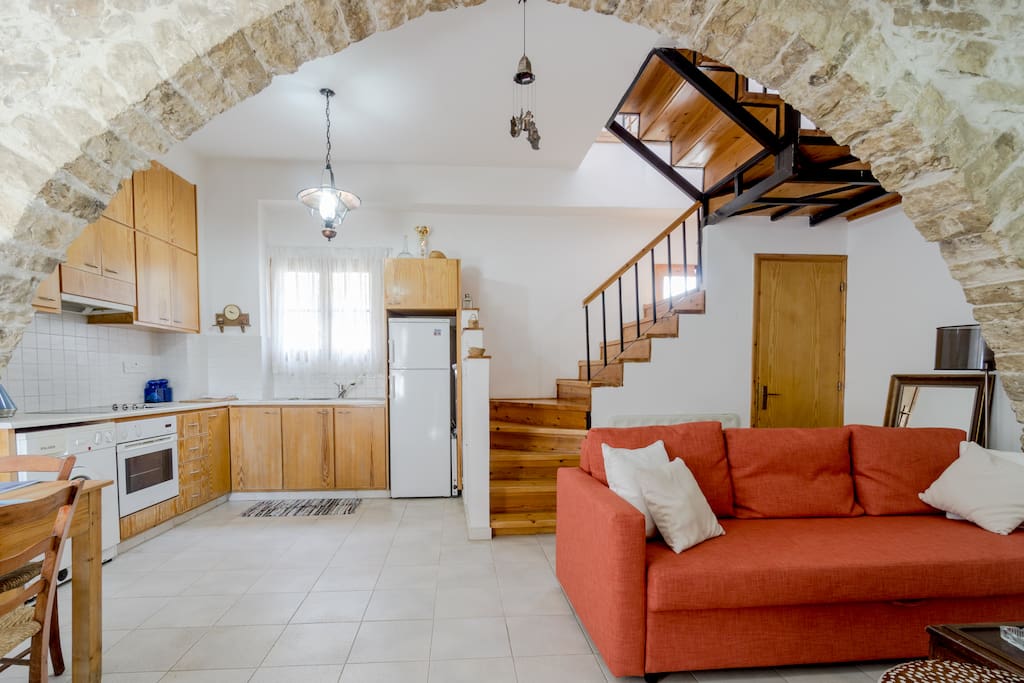 Living room with fireplace and fully equipped kitchen