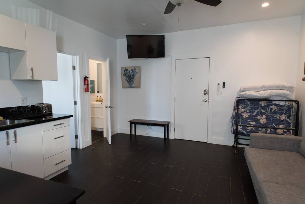 Looking toward the front entry door and entrance to the bathroom and bedroom.
