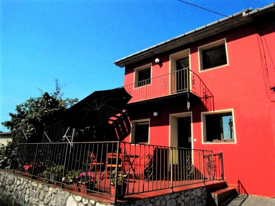 stairs and a balcony lead to the apartment located on the 1st floor