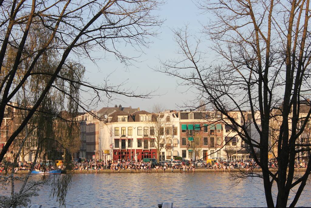 Revelers enjoy the sunset across the river
