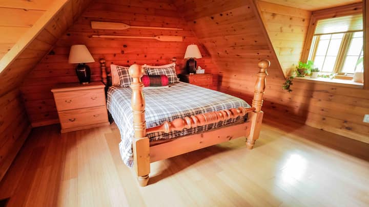 Spacious master bedroom (bedroom #1) features a comfy Queen-sized bed and has plenty of room. Windows flank the bed facing North & South, giving this room both forest & partial lake views.