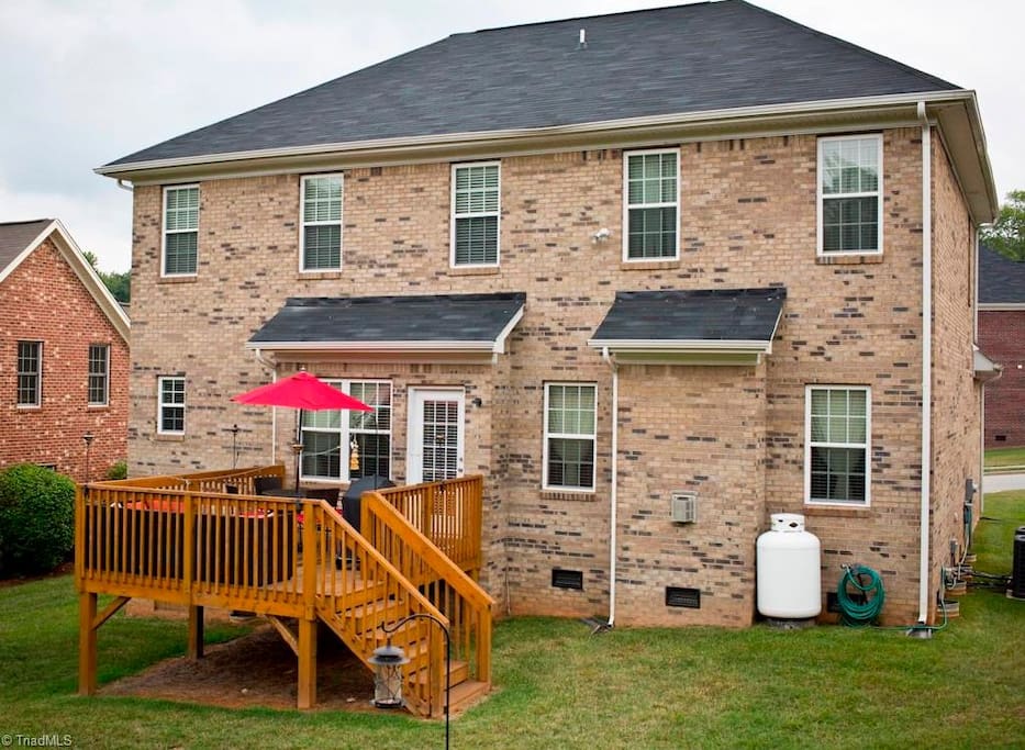 Back yard and porch with grill and umbrella