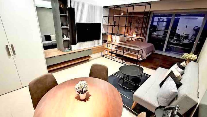 Living area with sofa bed and a 55 inches of Smart TV with Netflix subscription.