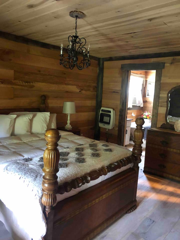Master bedroom with propane wall heater for cold weather.