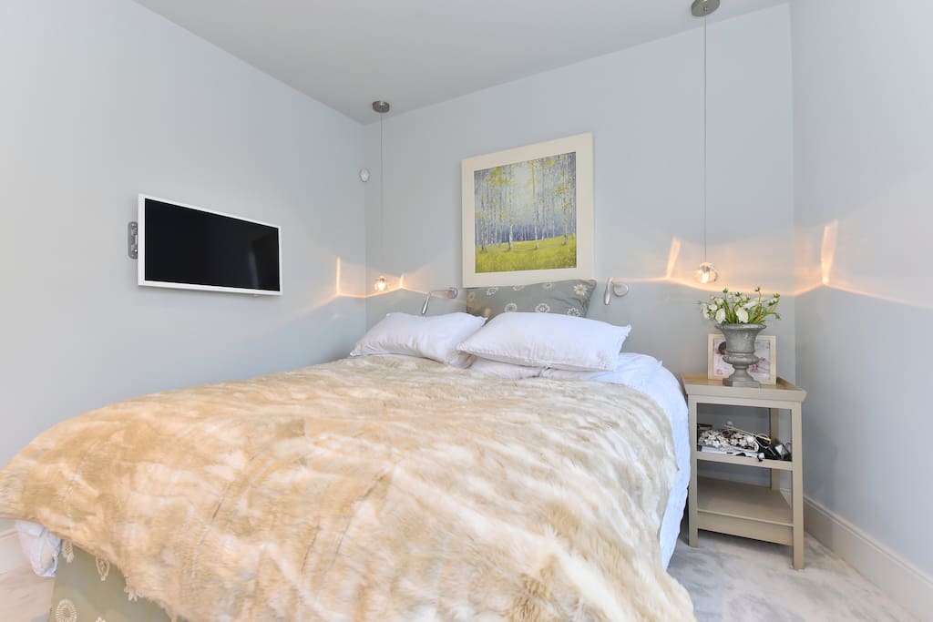 View of the master bedroom cozy bed