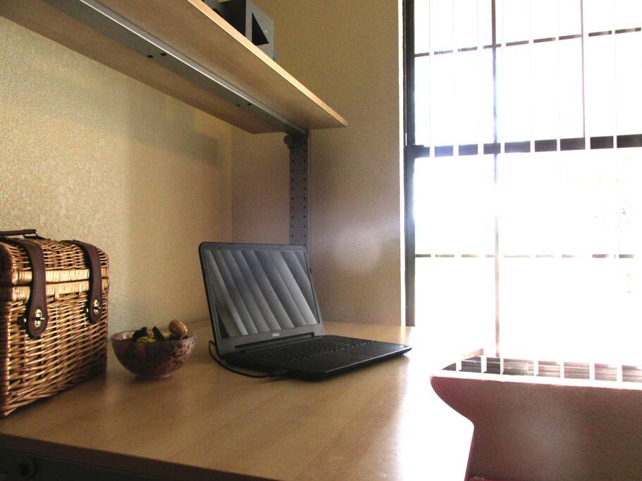 Personal desk and window with a sunny view.