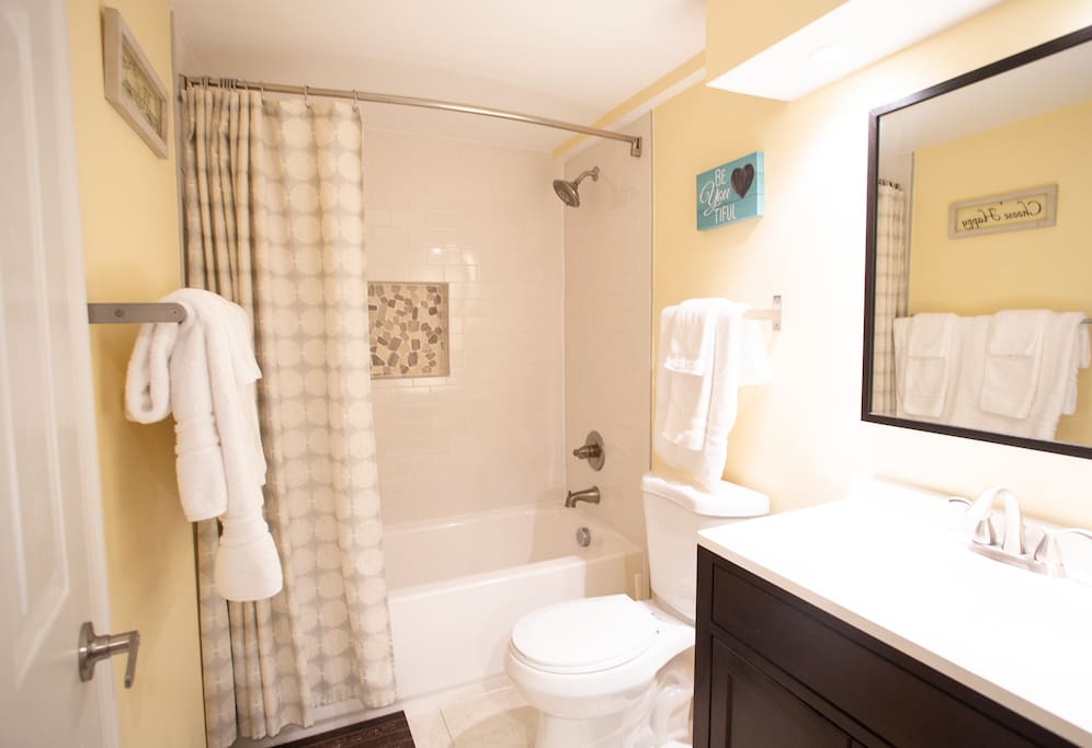 Bathroom area with refreshing full shower and soaking tub. Fresh towels, delicious shampoo, conditioner and body soap provided.