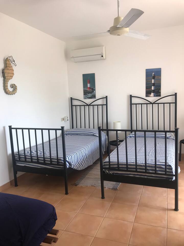 Room with two single beds, extra bed available upon request
Room with two single beds (additional bed available upon request)