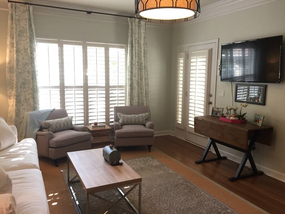 Living room with porch access, TV, couch pulls out into bed