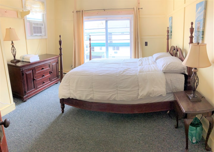 chumba cha kulala na kitanda cha ukubwa wa malkia kinachoelekea mbele ya nyumba.