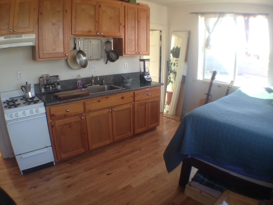 stove, gas range, granite counter tops, hardwood floors, ninja blender