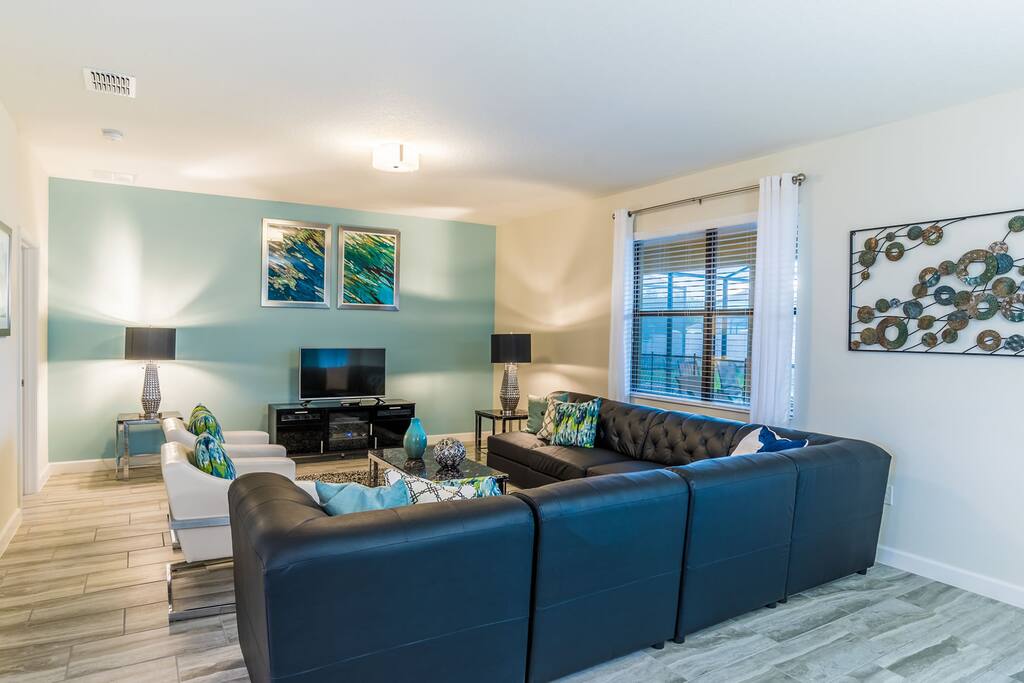 Second floor loft area with leather sofa and flat screen TV